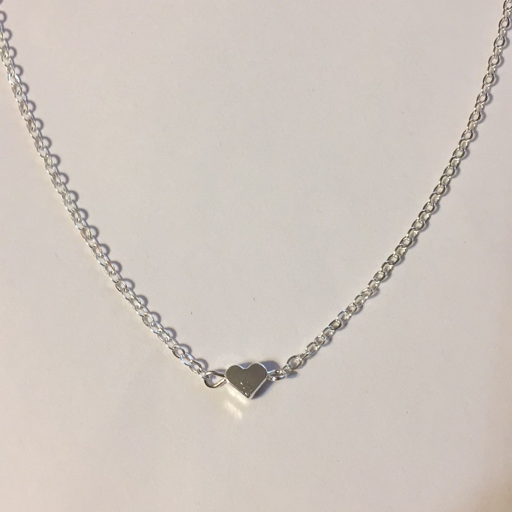 Silver tone necklace with heart pendant